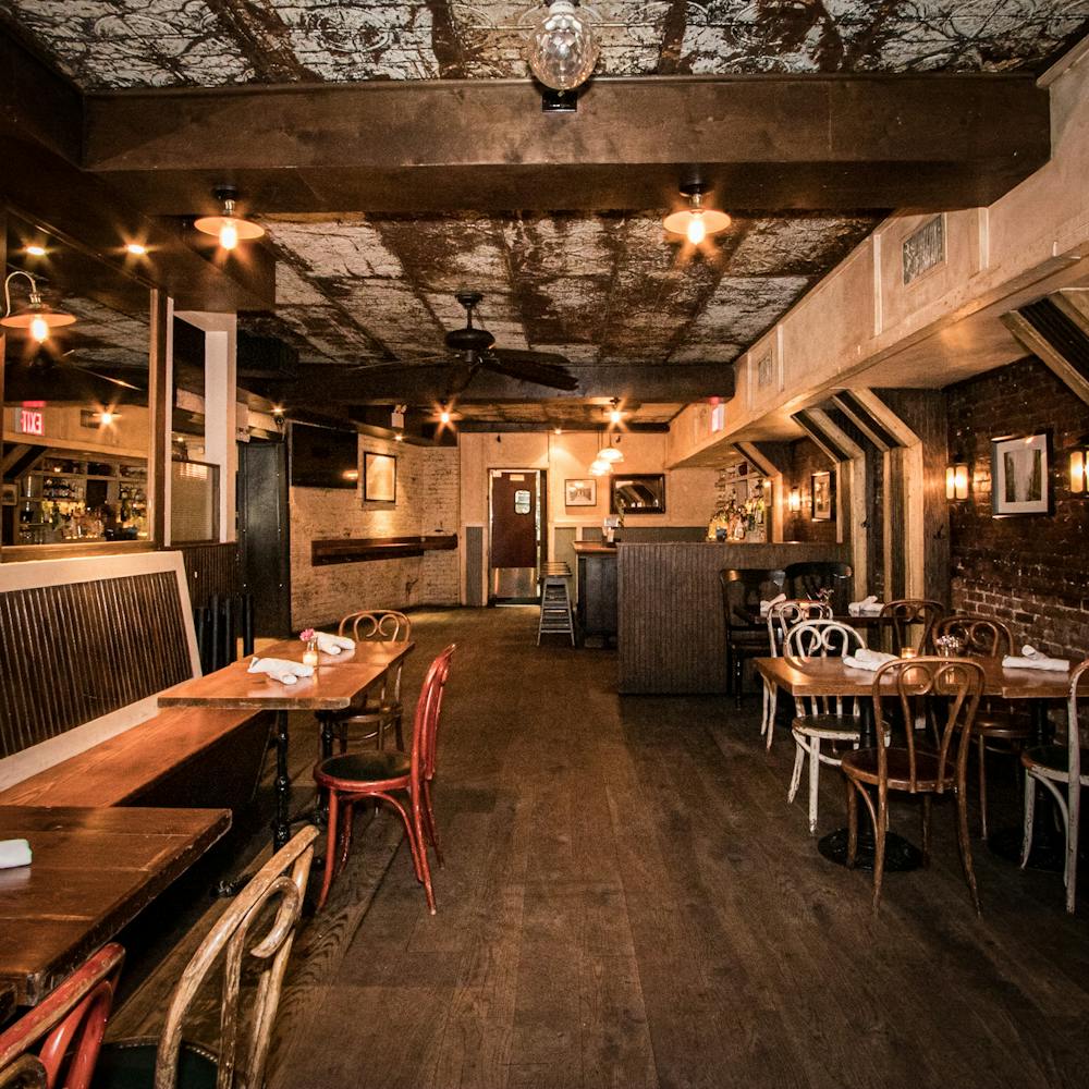 a group of people sitting at a table in front of a building