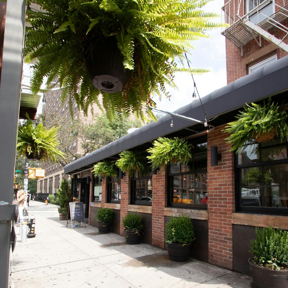 a person walking down a street next to a brick building