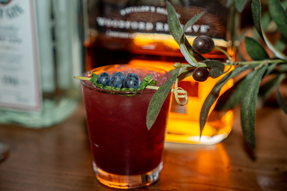 a vase filled with flowers sitting on top of a wooden table