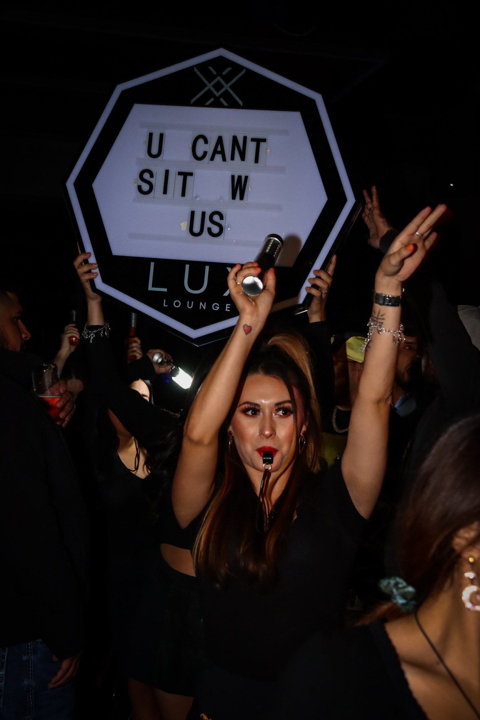 a woman standing in front of a crowd posing for the camera
