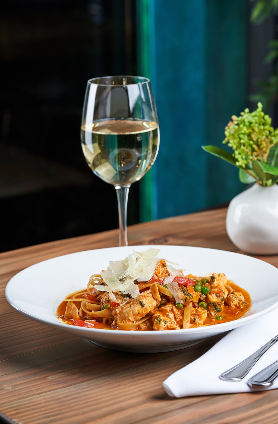 a plate of food and a glass of wine
