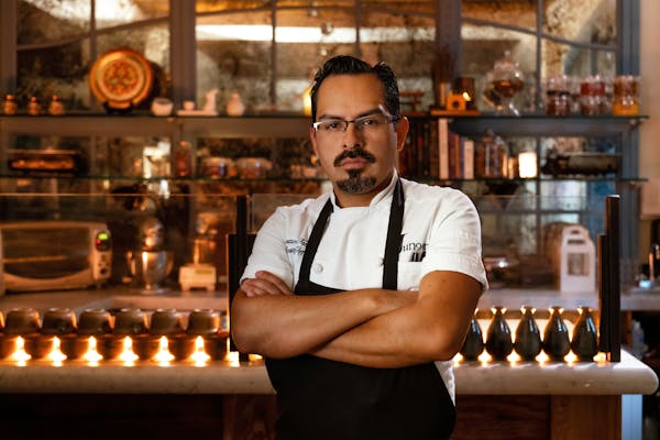 a man standing in front of a restaurant