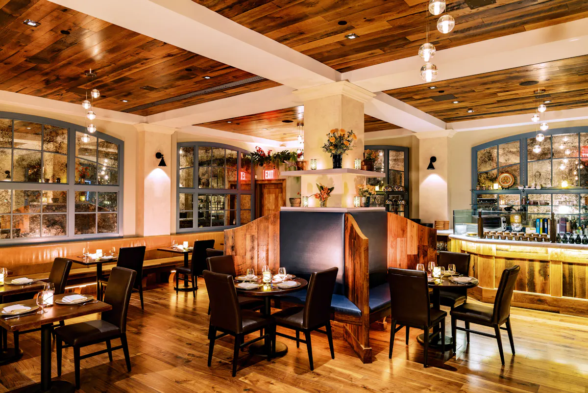 a dining room filled with furniture and a large window