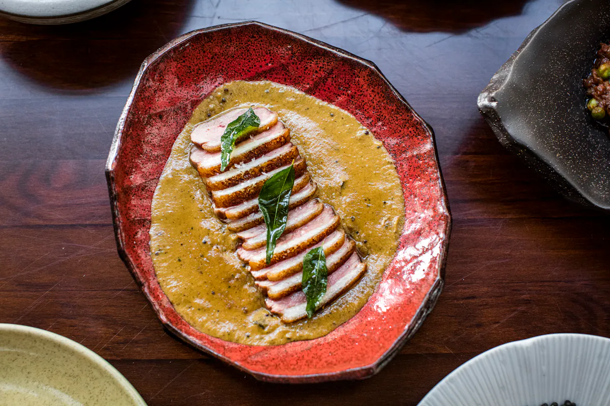 a plate of food sitting on top of a wooden table