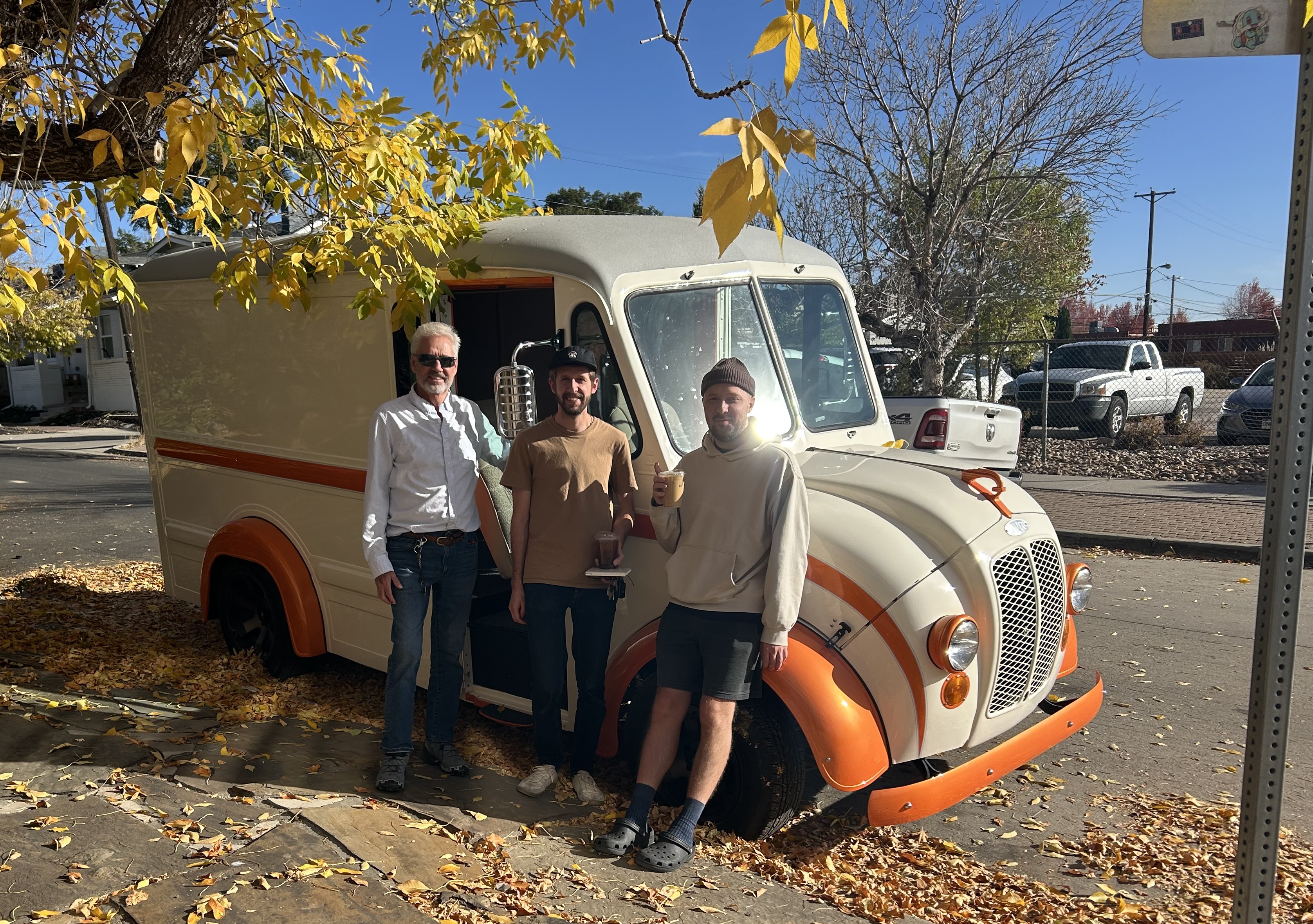 a group of people standing around a fire truck parked in a parking lot
