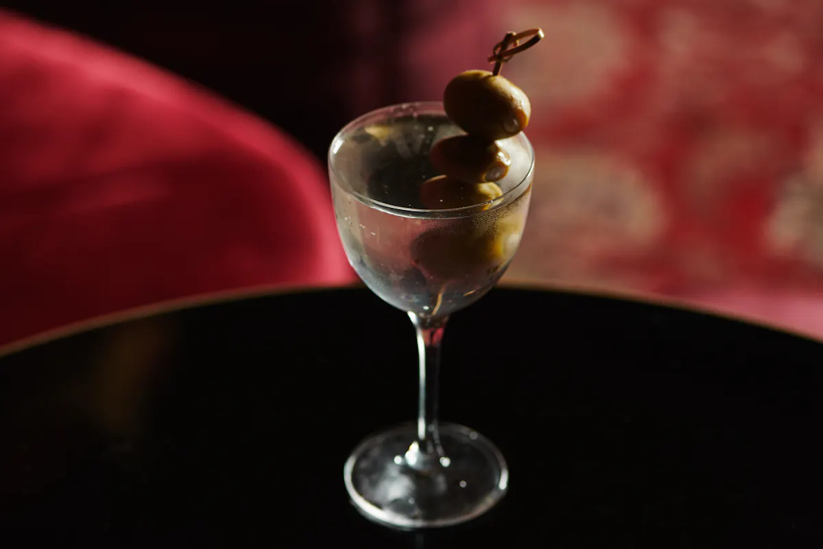 a close up of a glass bowl full of red wine