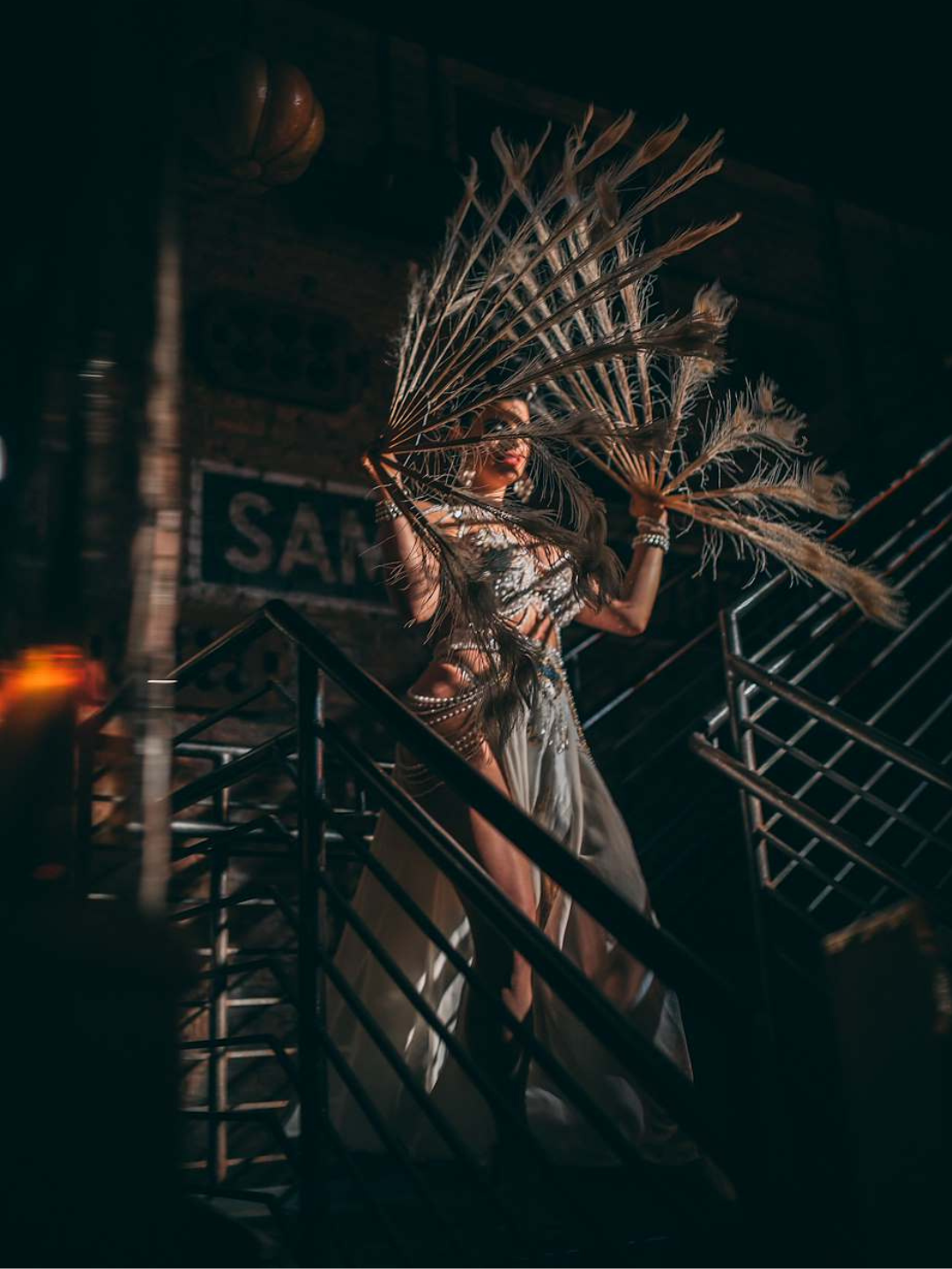 Woman walking down the stairs of The Ragtrader in extravagant burlesque outfit