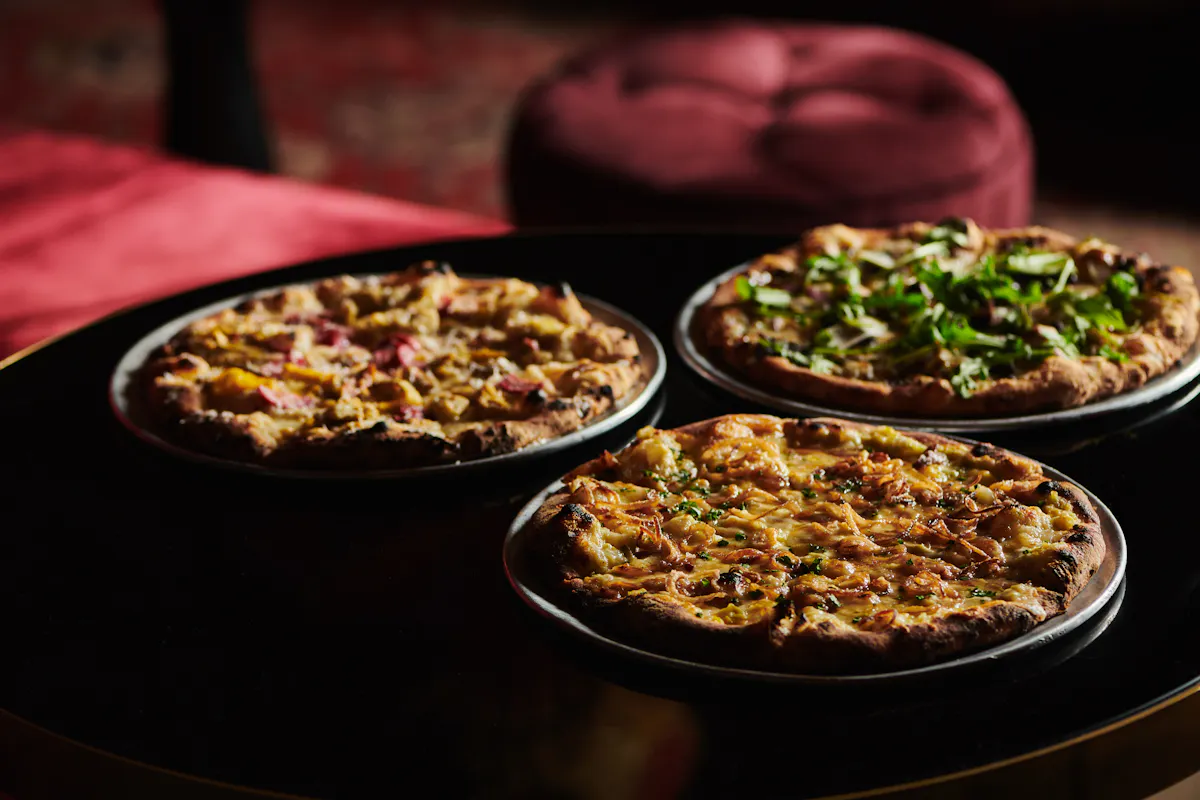 a pizza sitting on top of a pan on a table