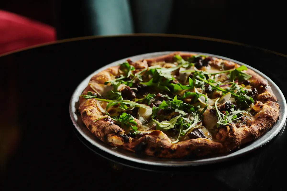 a pizza sitting on top of a pan on a table