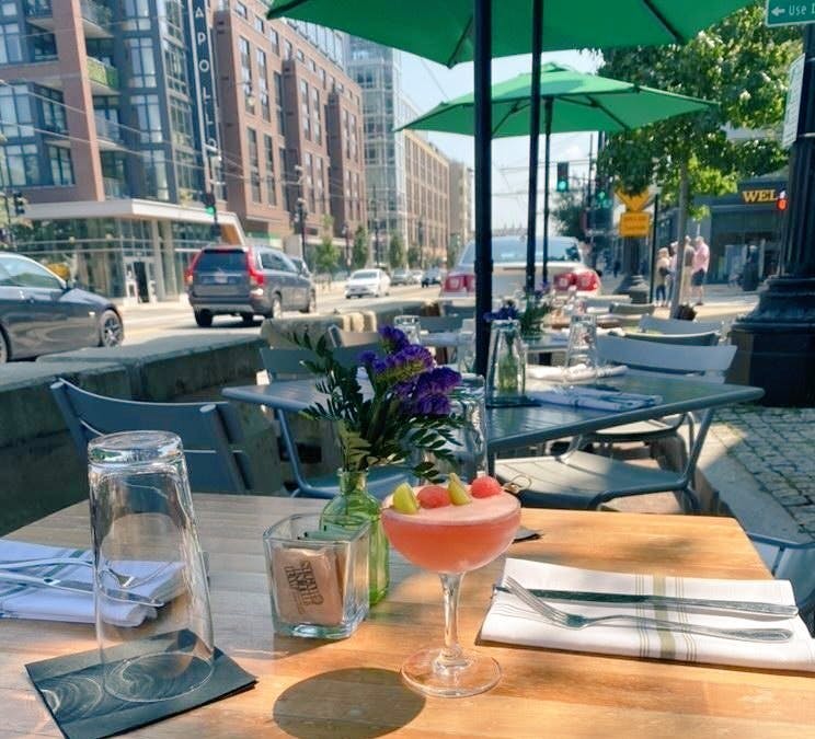 a person sitting at a table with a city in the background