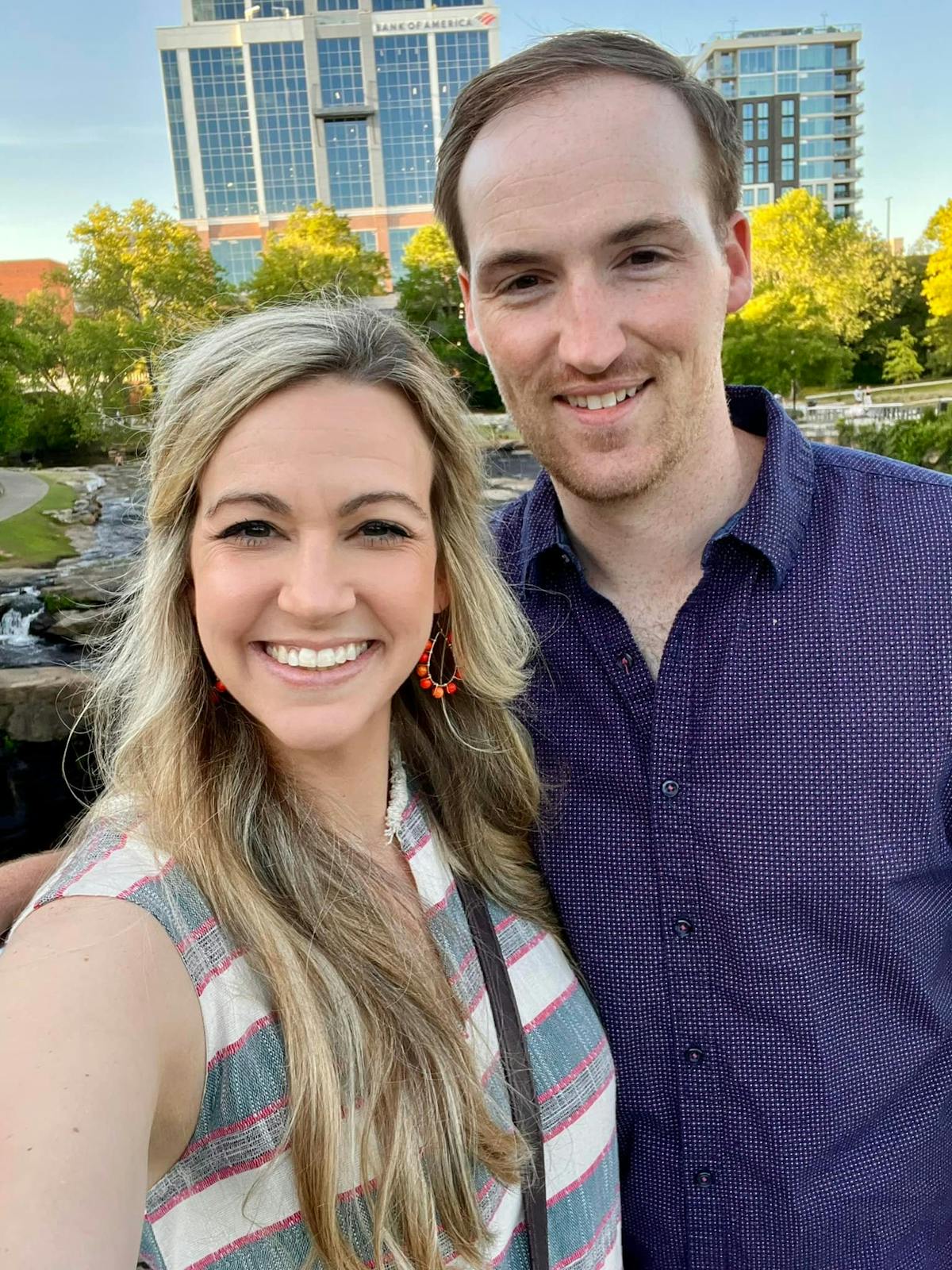 a smiling man and woman posing for a photo