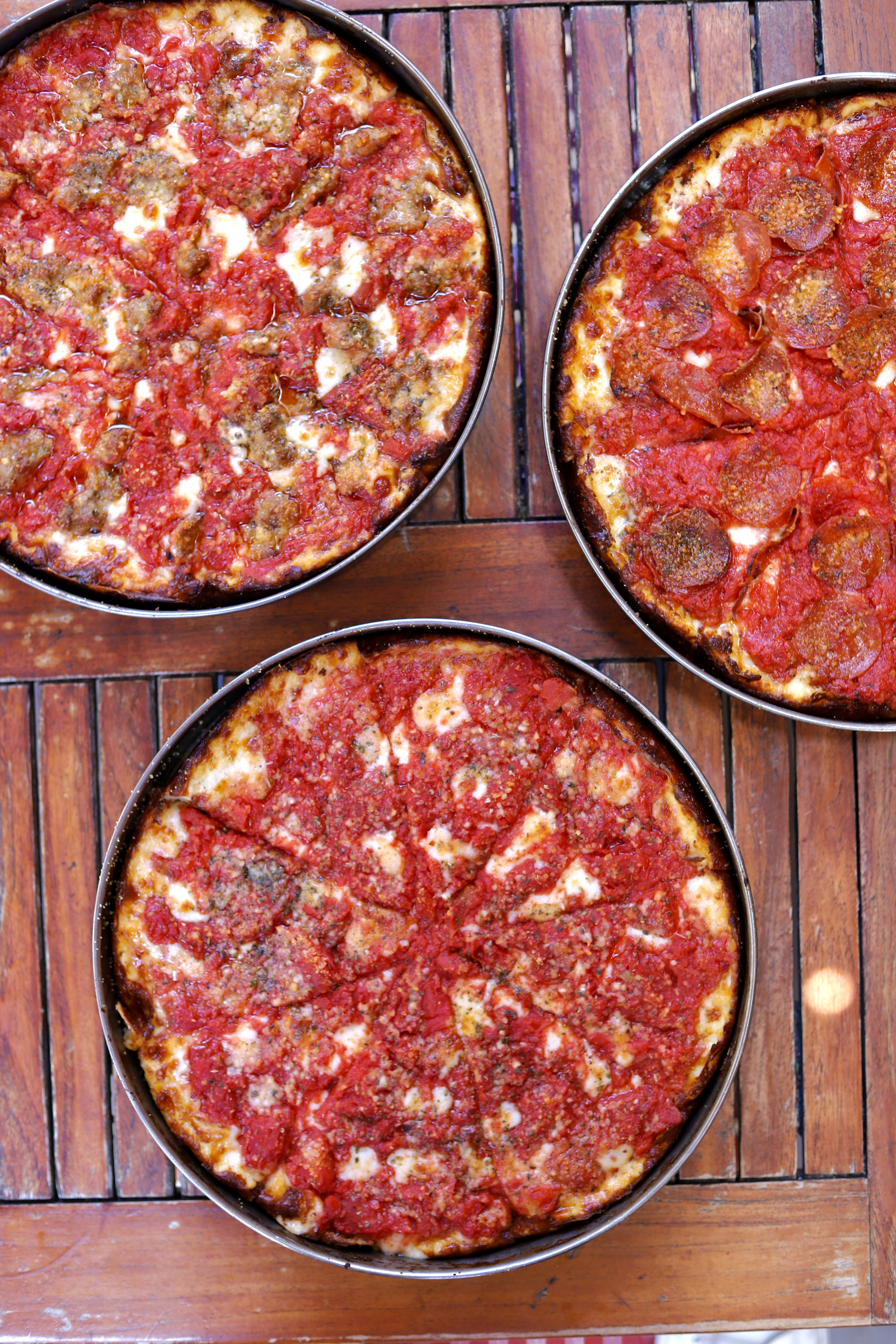 a pizza sitting on top of a wooden table