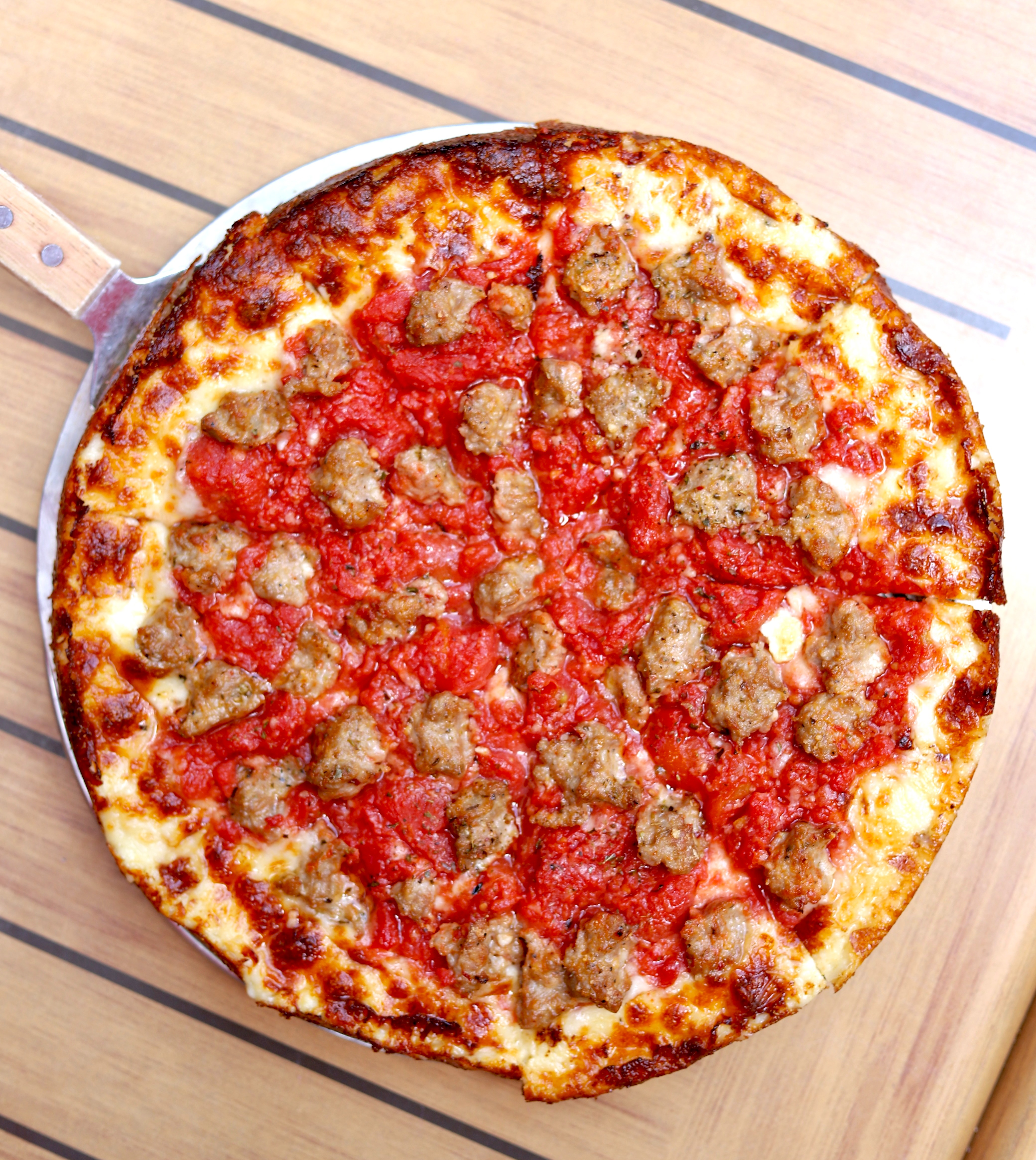 a pizza sitting on top of a wooden cutting board