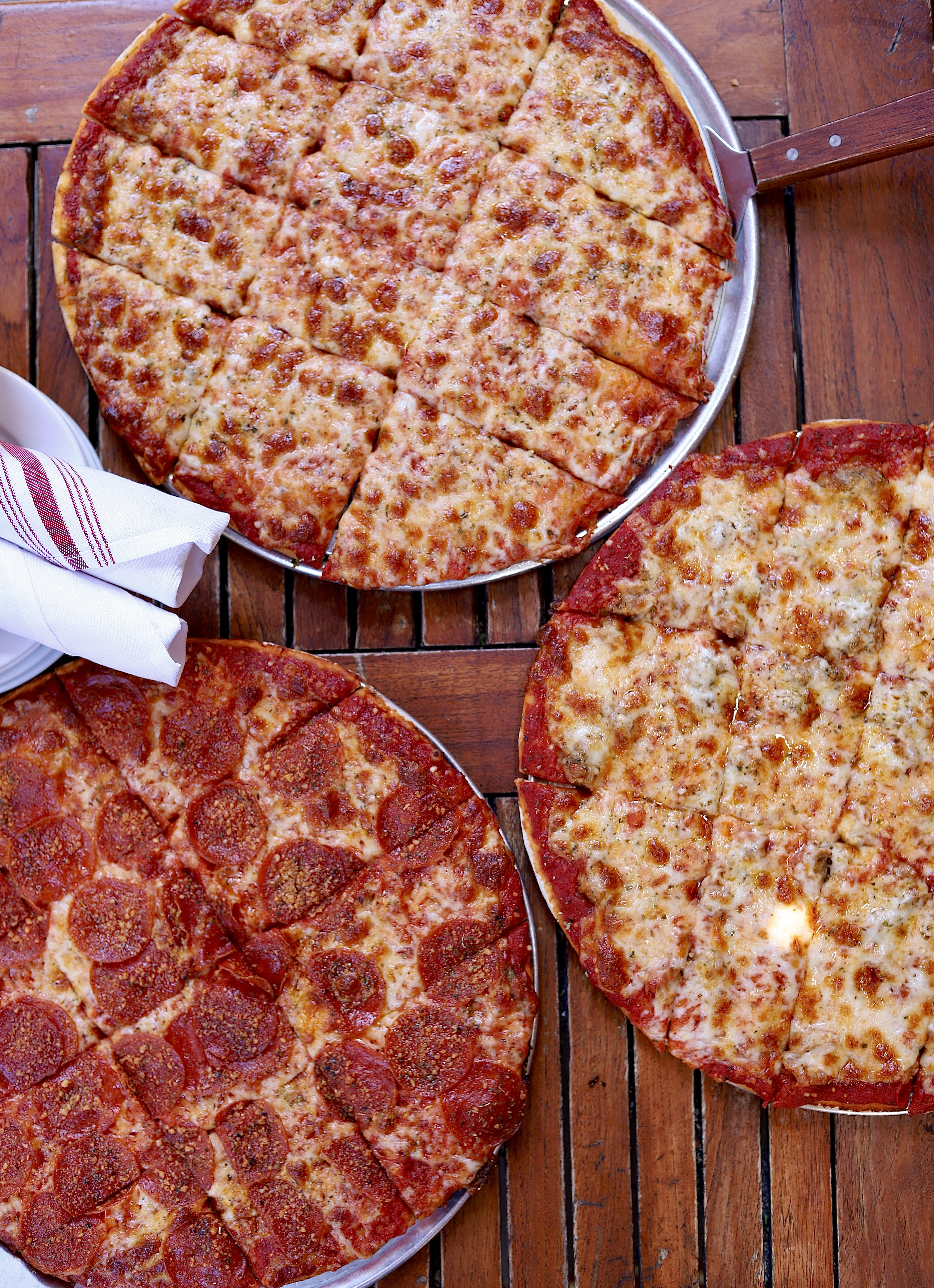 a pizza sitting on top of a wooden table