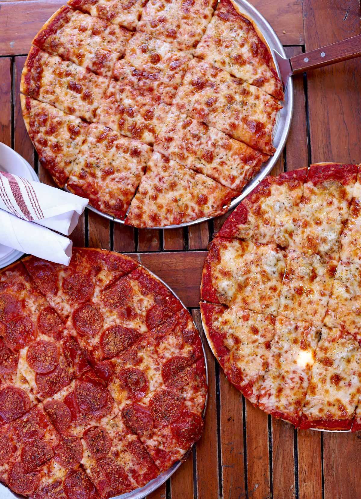a pizza sitting on top of a wooden table