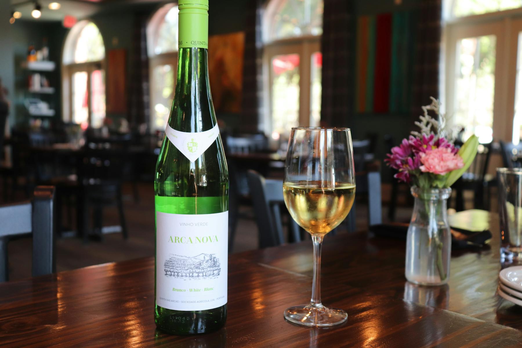 a close up of a bottle and a glass of wine