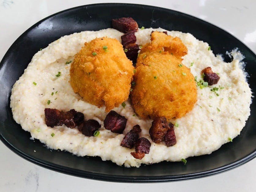 a plate of food with rice meat and vegetables