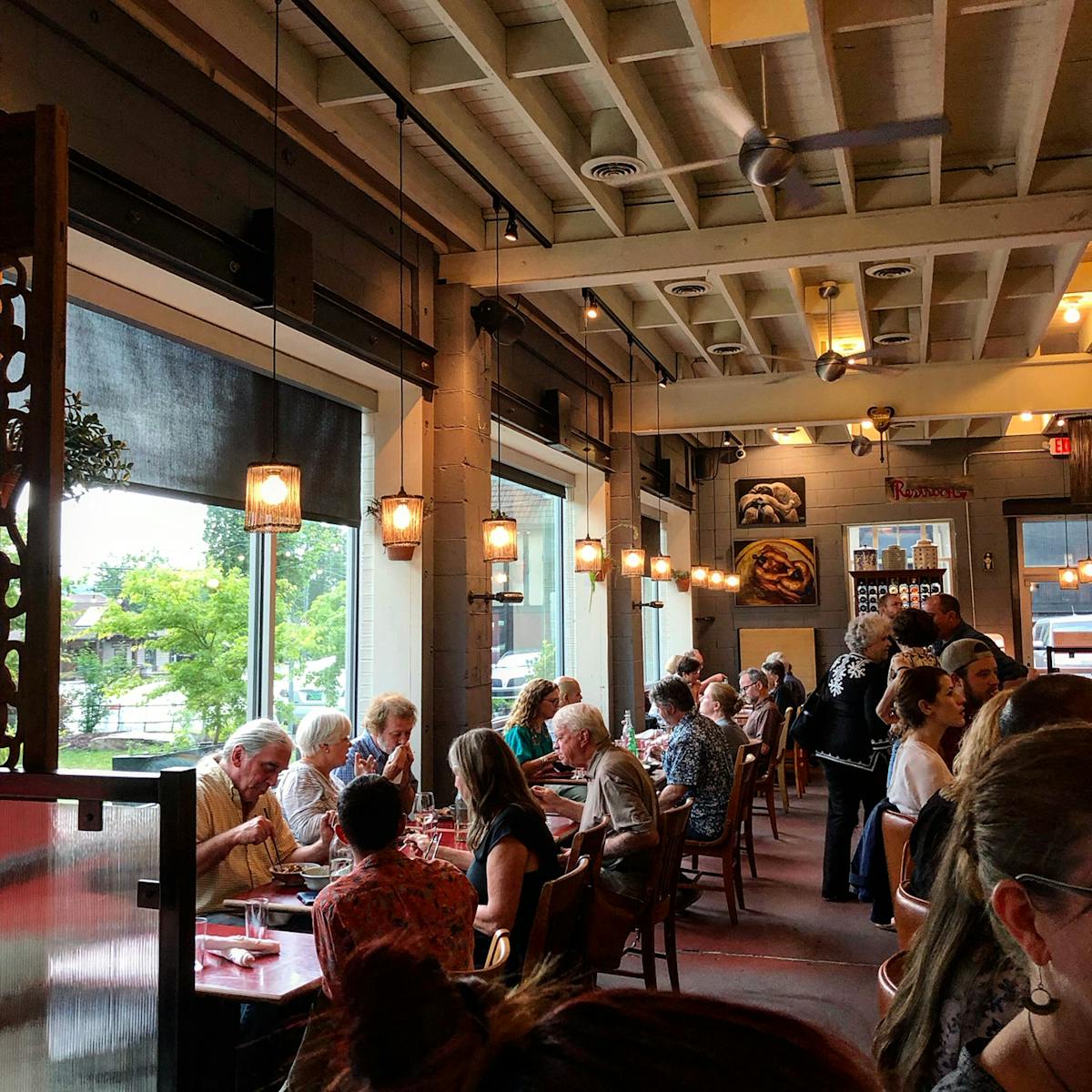 a group of people sitting at a table in a restaurant