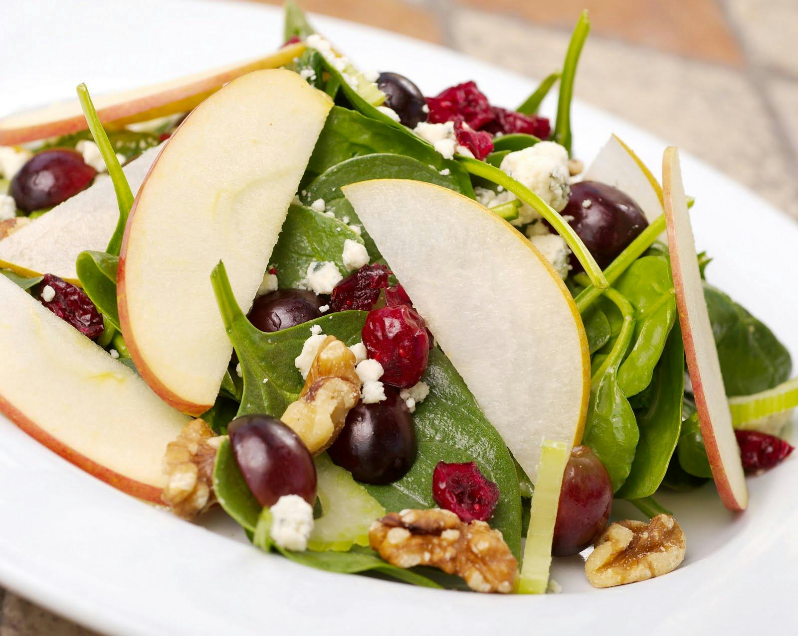 a plate is filled with fresh fruit and vegetables