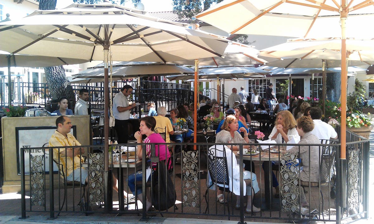 a group of people sitting at a table in a restaurant