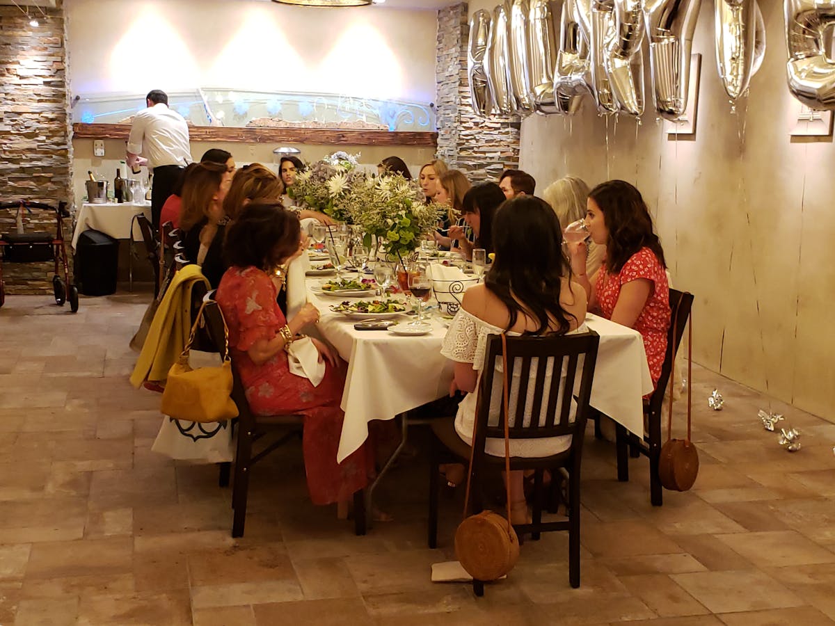 a group of people sitting at a table in a room