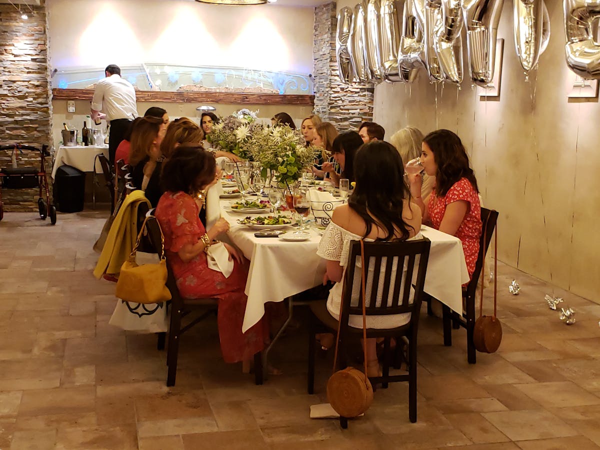 a group of people sitting at a table in a room