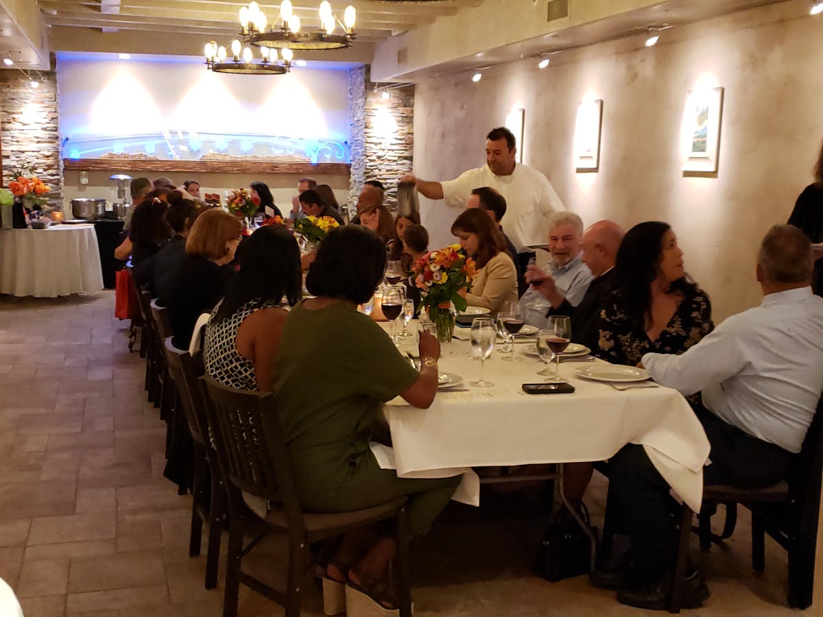 a group of people sitting at a table in a restaurant