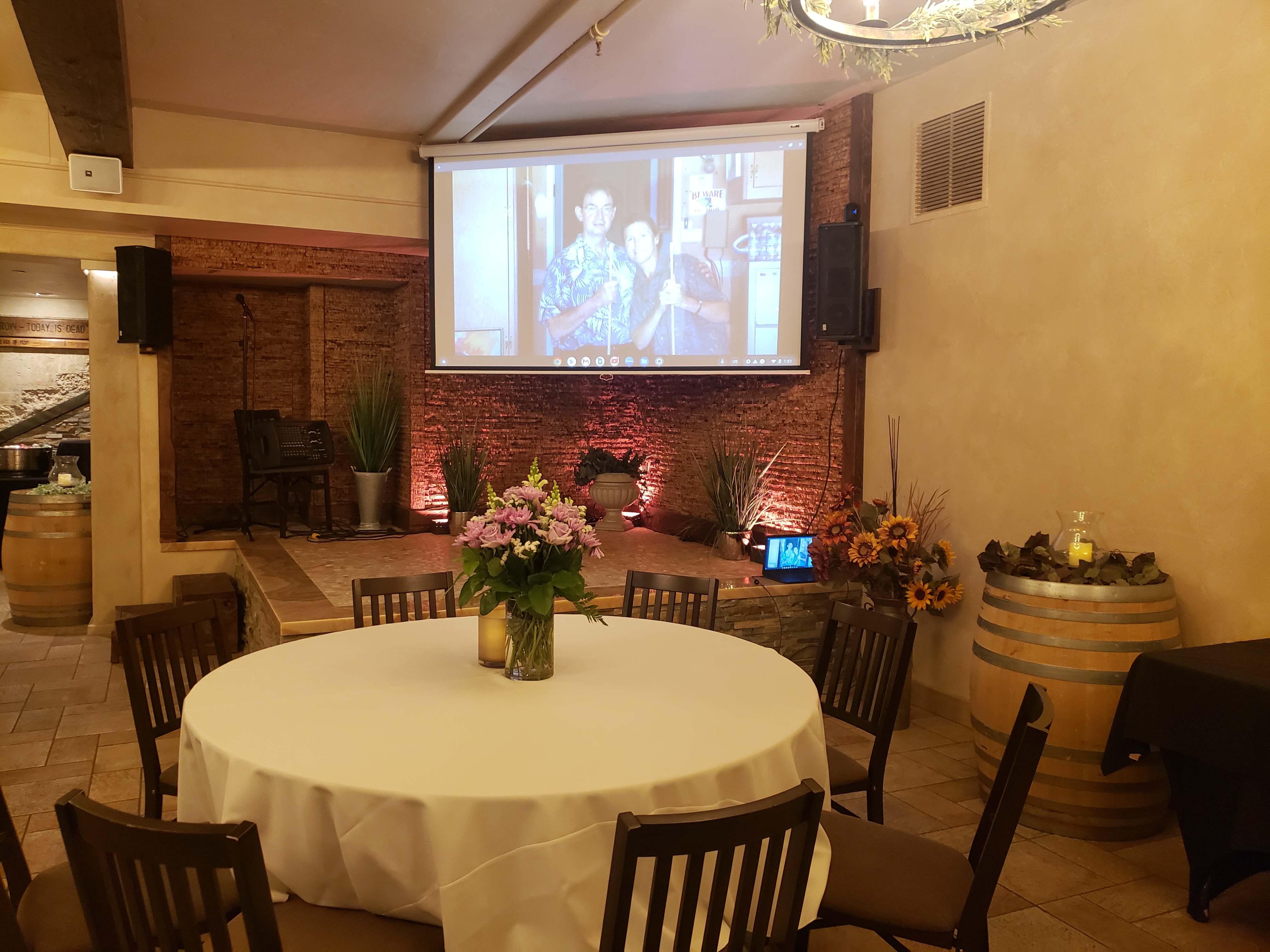 a living room filled with furniture and vase of flowers on a table