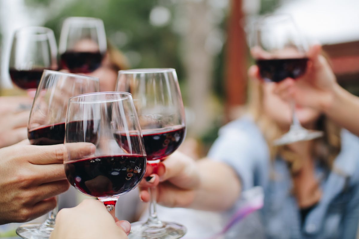 a woman holding a glass of red wine