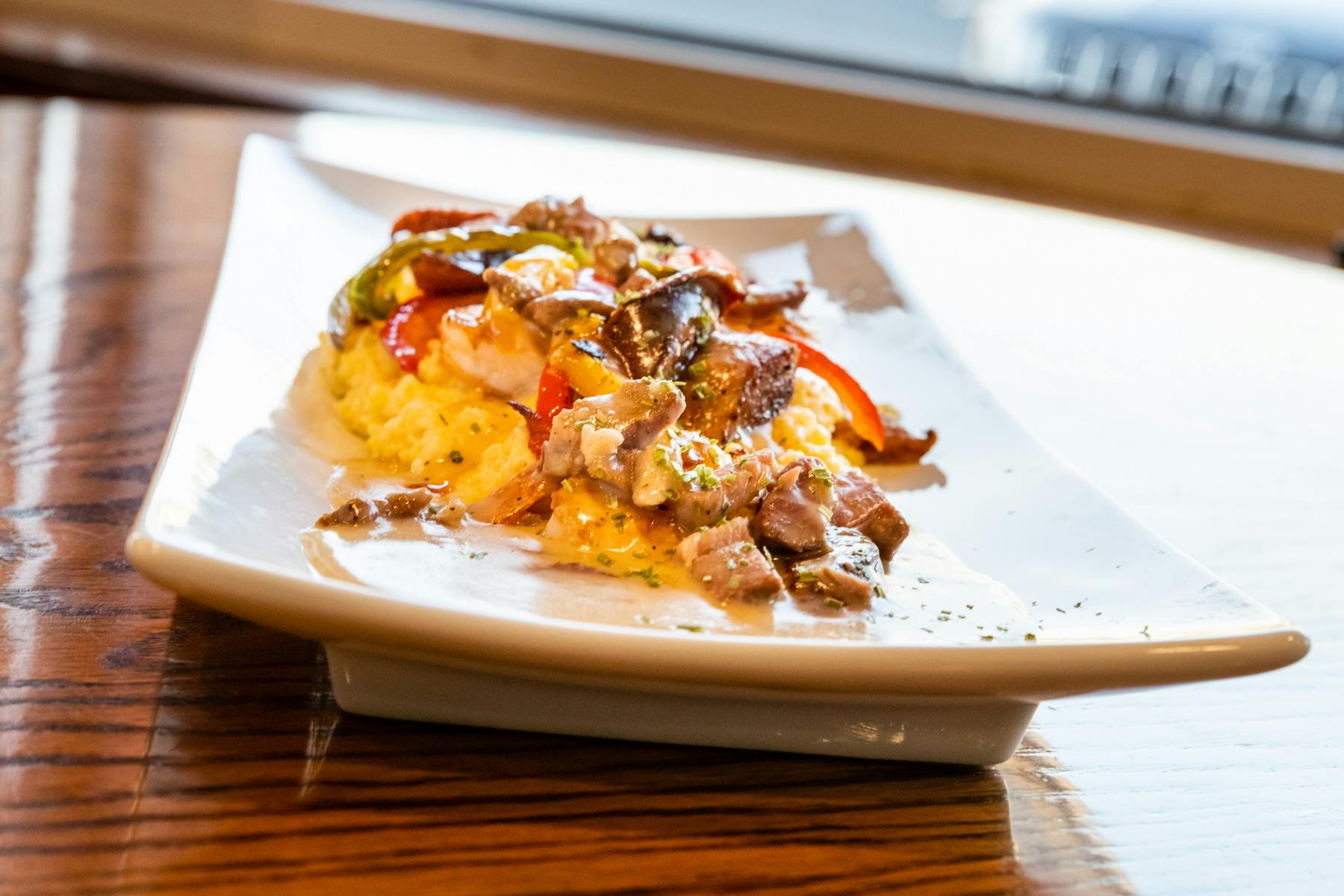 a plate with smashed potatoes and meat