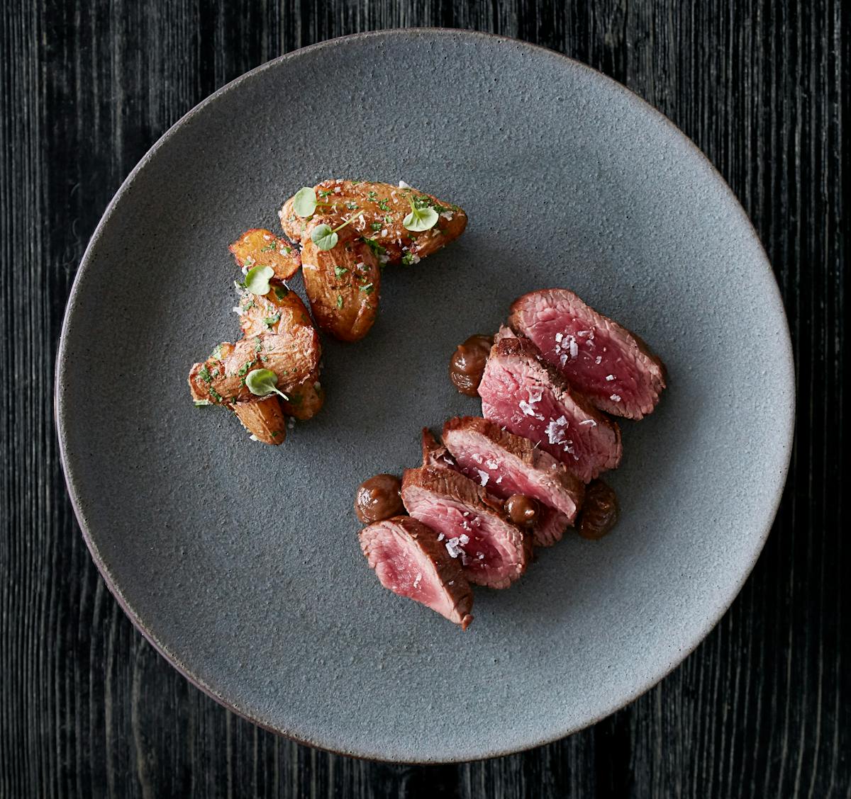 a plate of food sitting on top of a wooden table