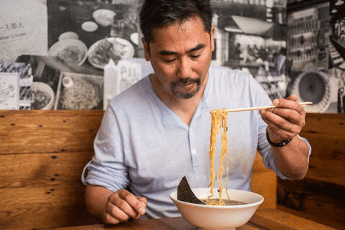 a person eating ramen