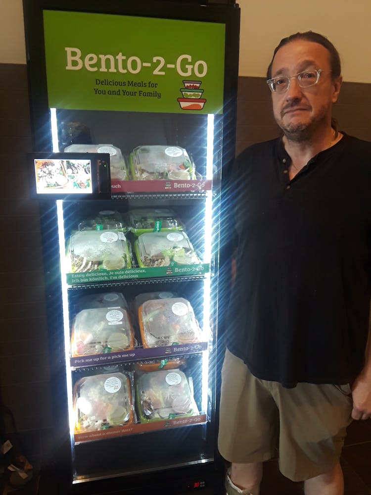 a man standing in front of a refrigerator