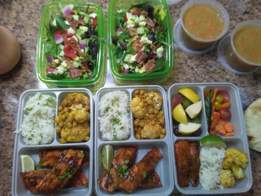 a plastic container filled with different types of food on a tray