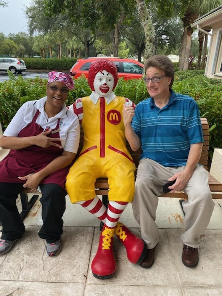 a group of people sitting on a bench posing for the camera