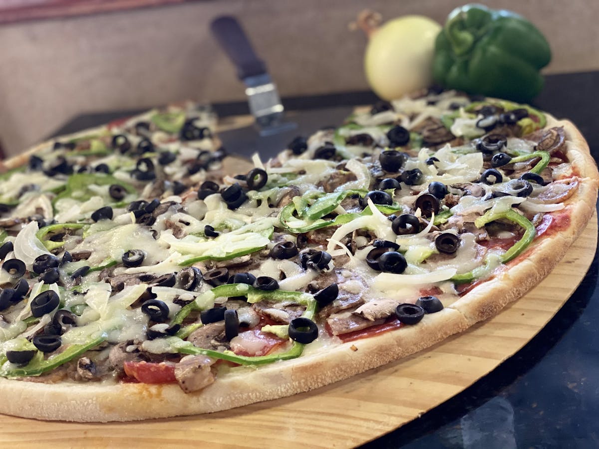 a pizza sitting on top of a wooden cutting board