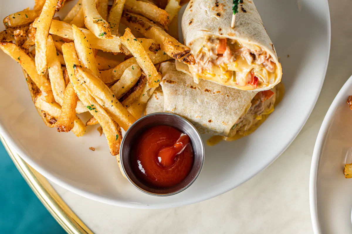 breakfast burrito with fries and ketchup.