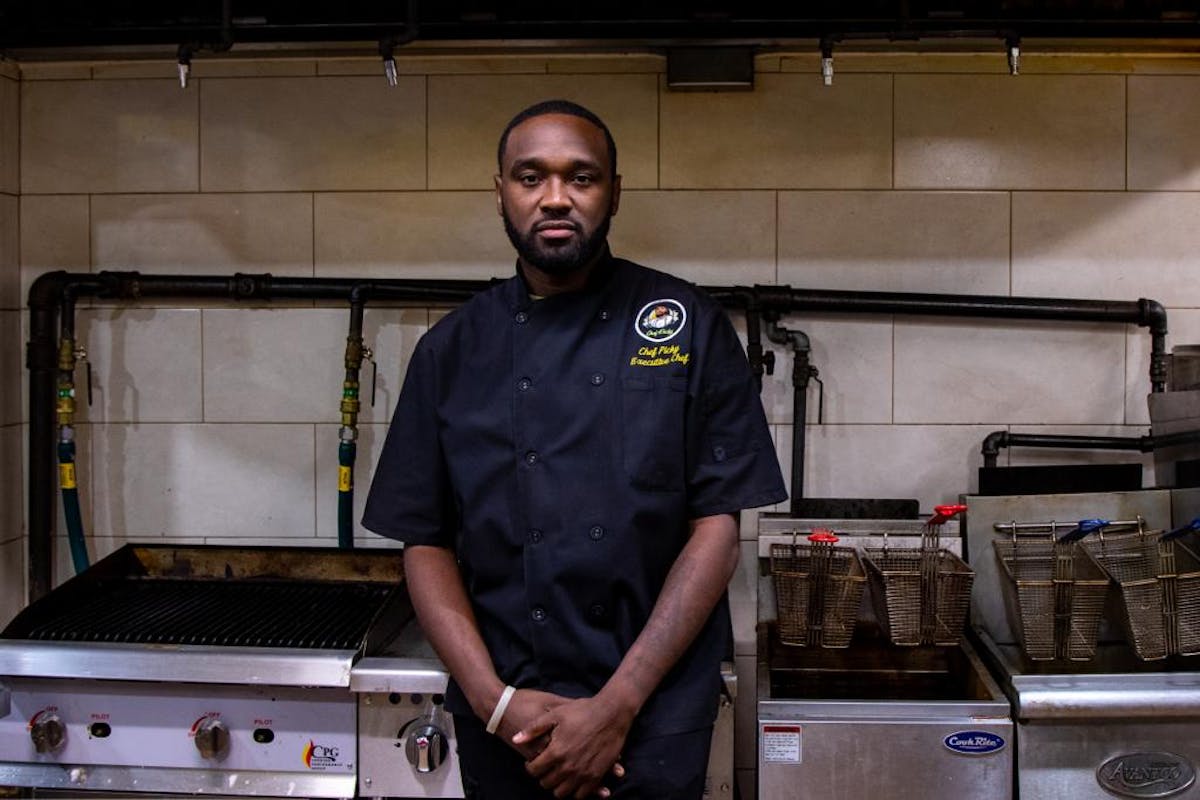 a man standing in front of a stove