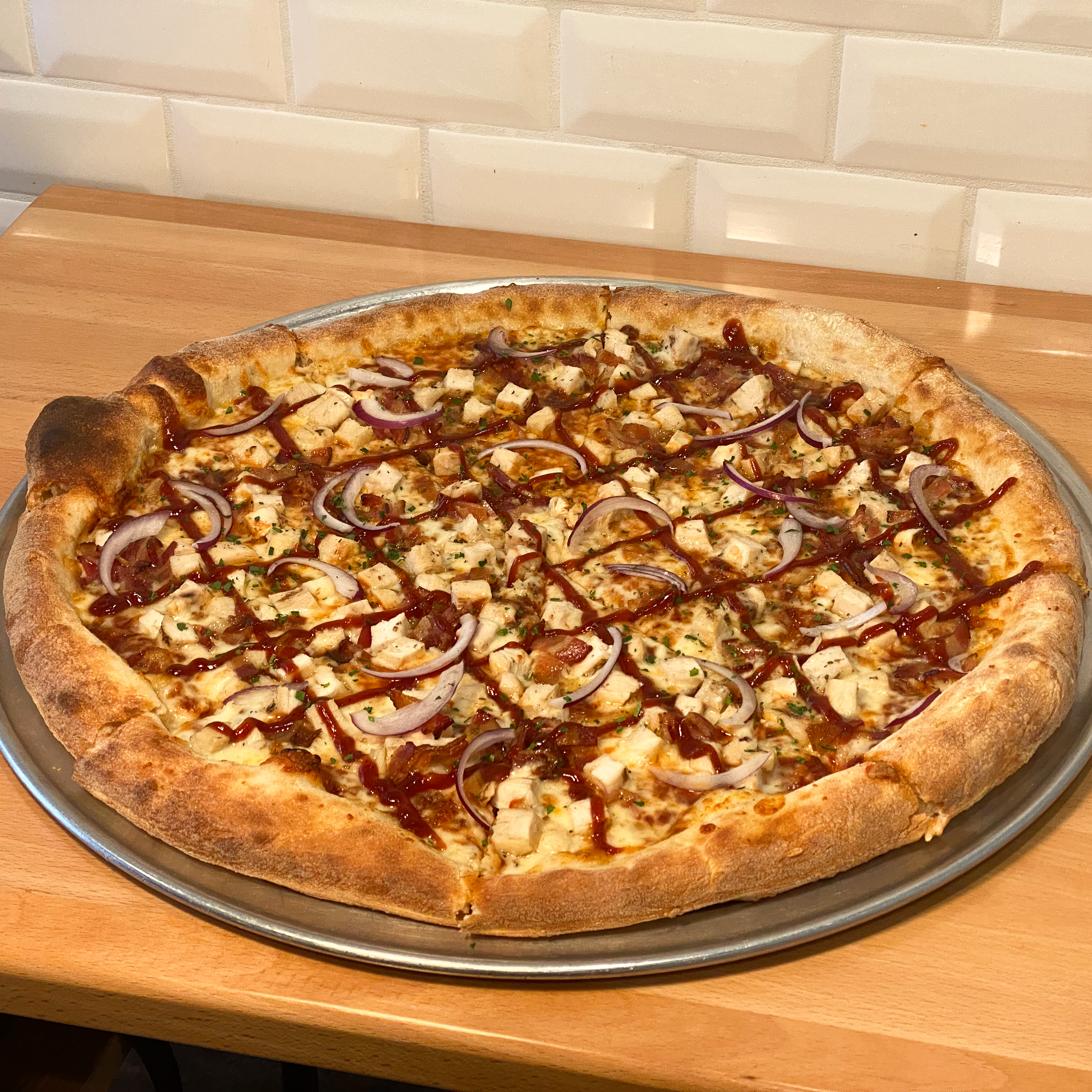 a pizza sitting on top of a pan on a table
