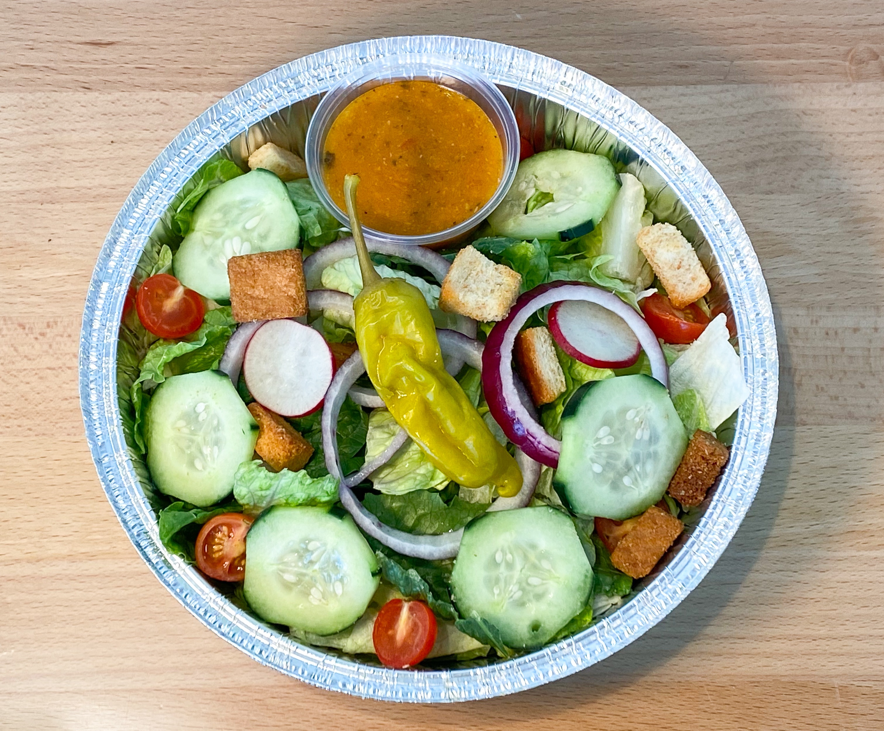 a bowl of salad with dressing