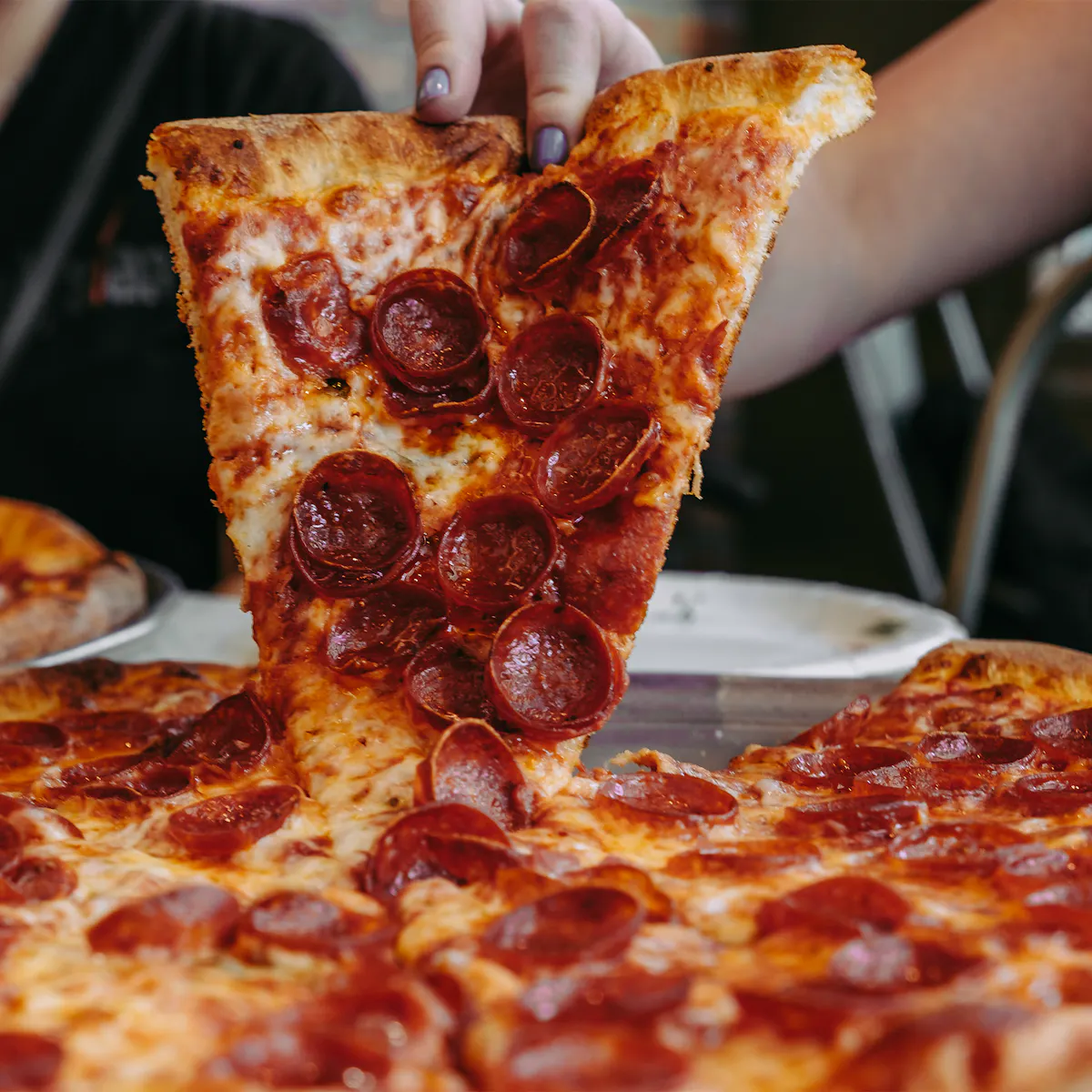 a slice of pepperoni pizza on a tray
