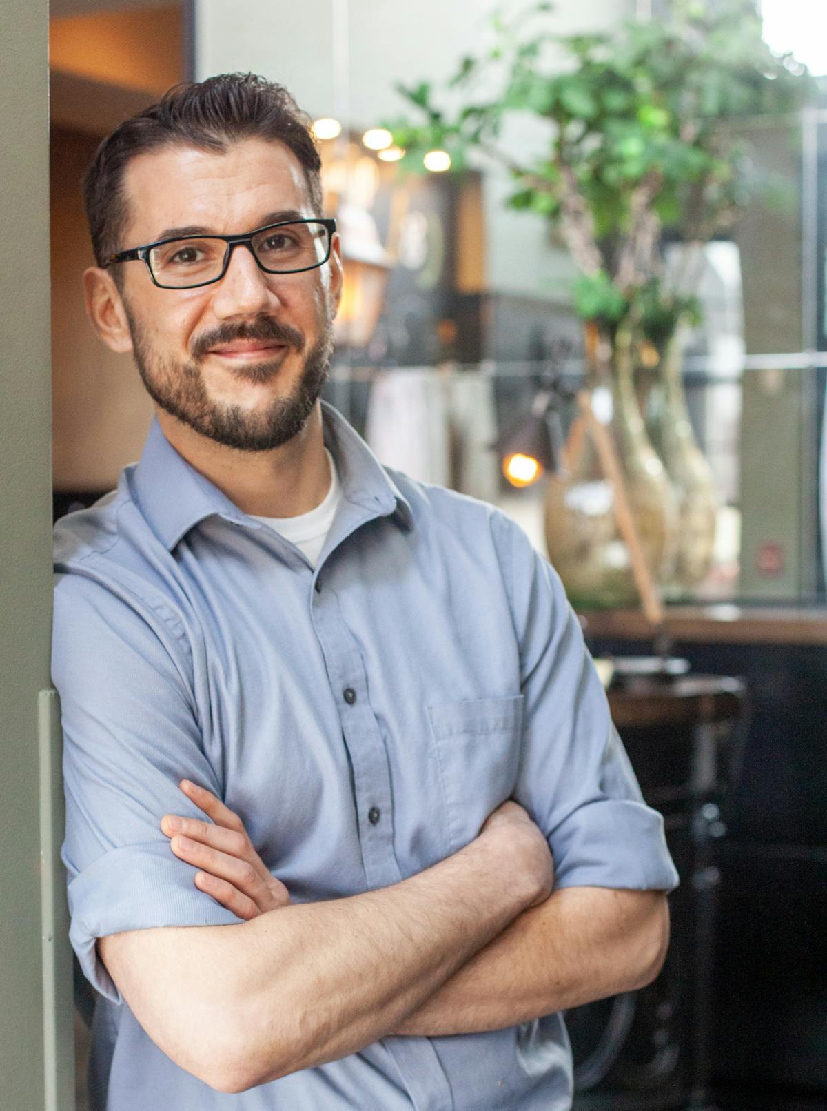 a man in glasses looking at the camera