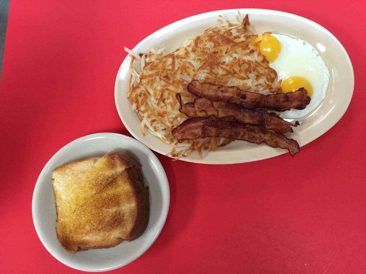 toast, hash brown, bacon and eggs