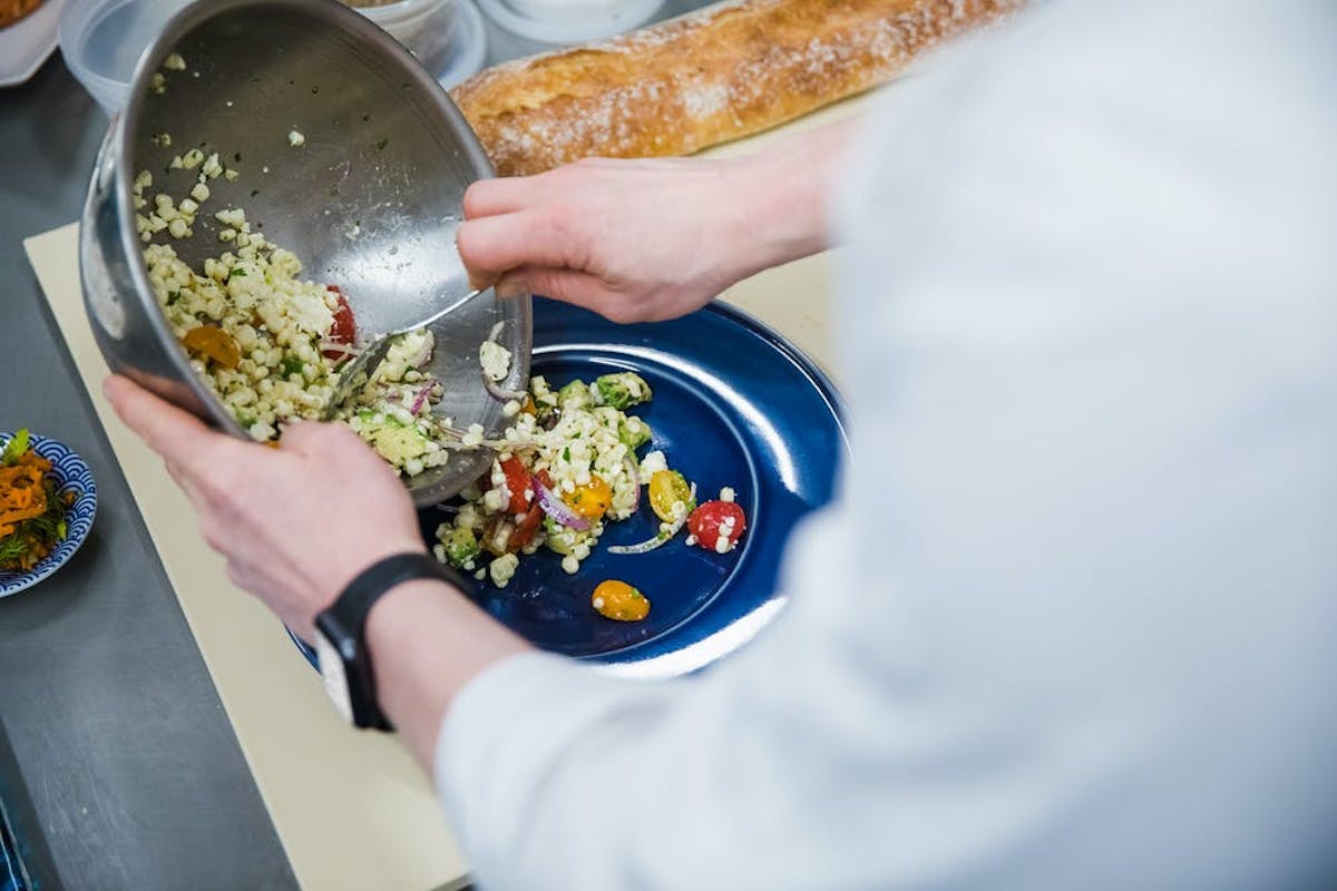 a person holding a plate of food