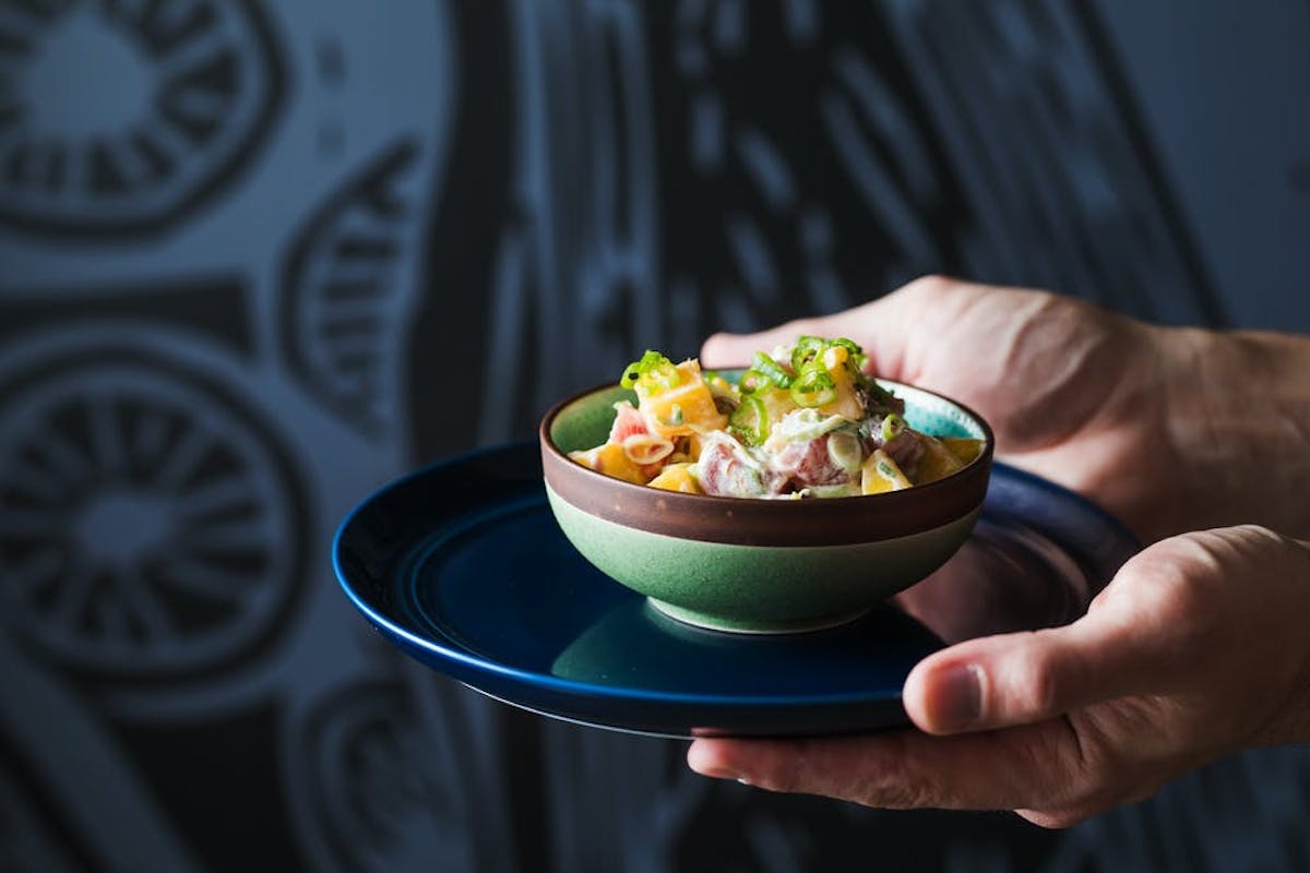 a person holding a bowl of food