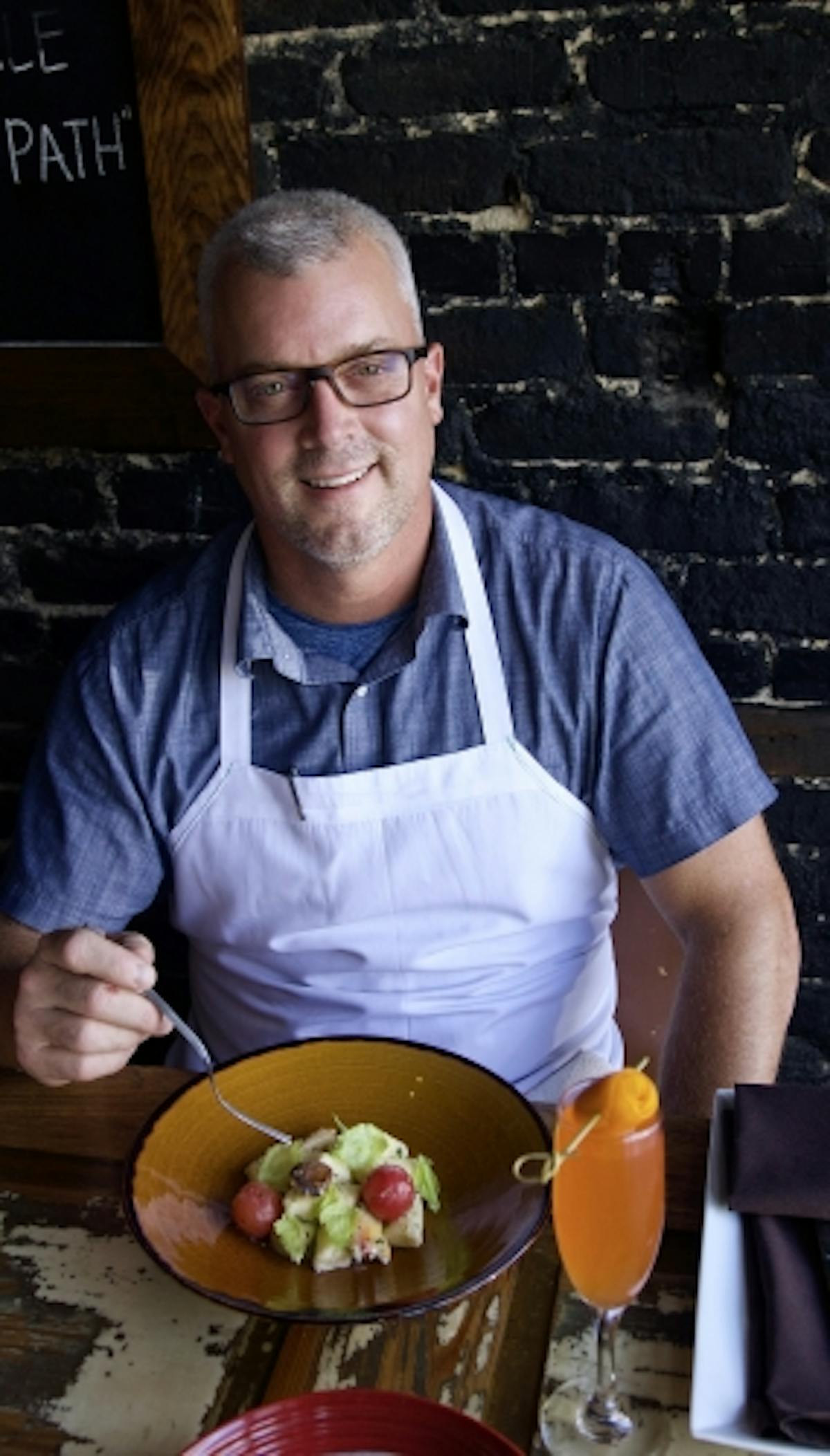 a man sitting at a table with food