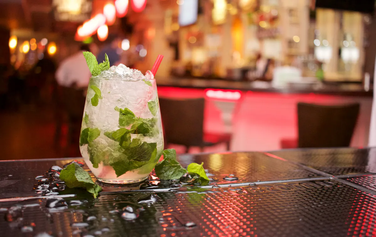 a vase of flowers on a table in a restaurant