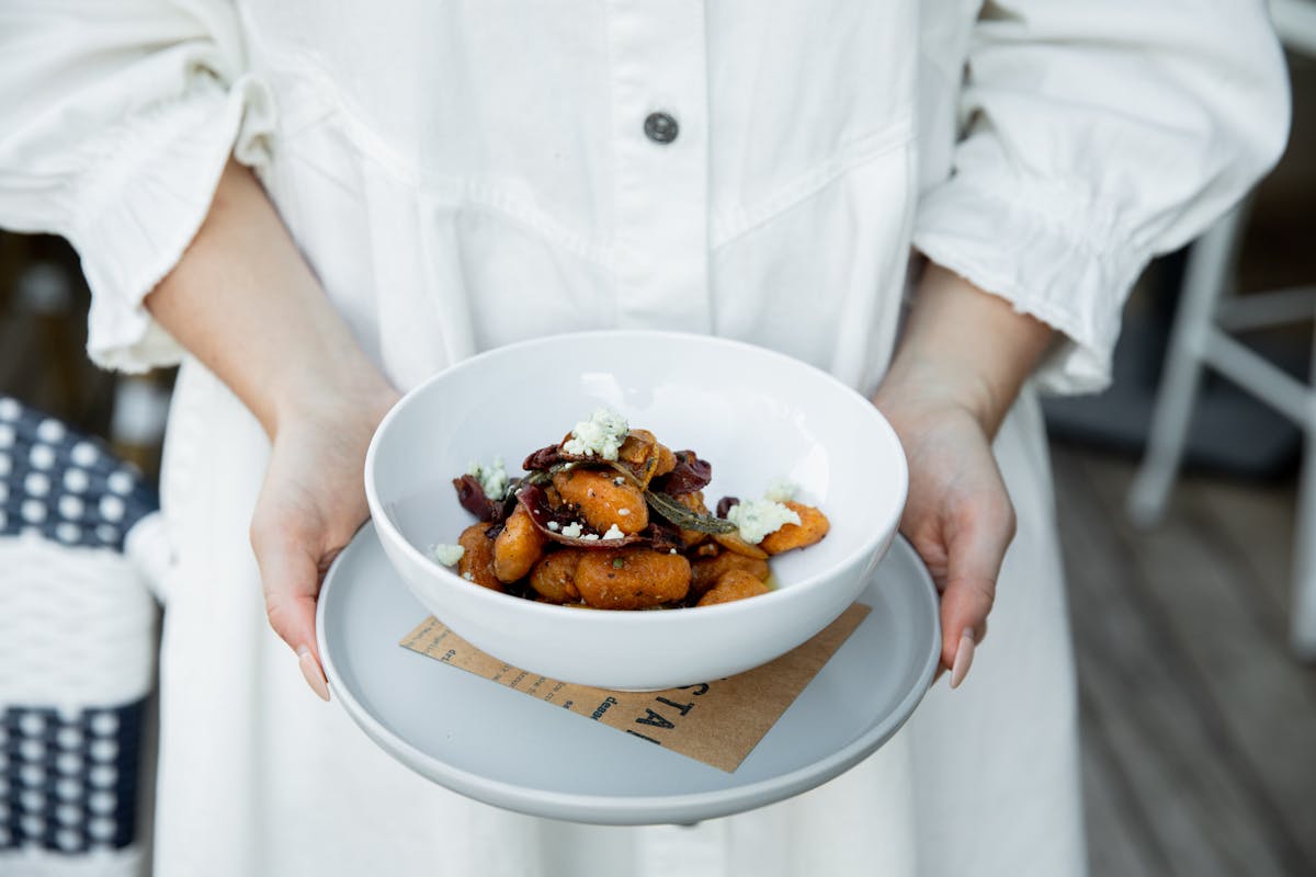 a person sitting at a table with a plate of food