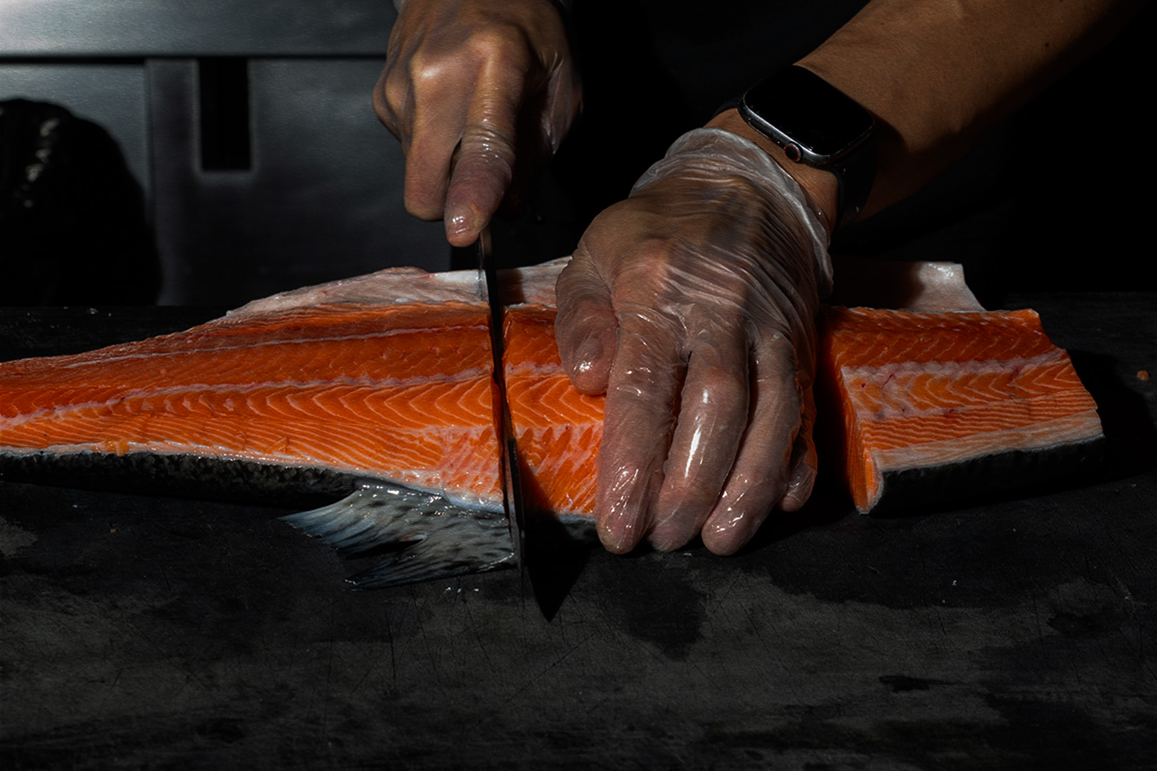 a person cutting food on a table