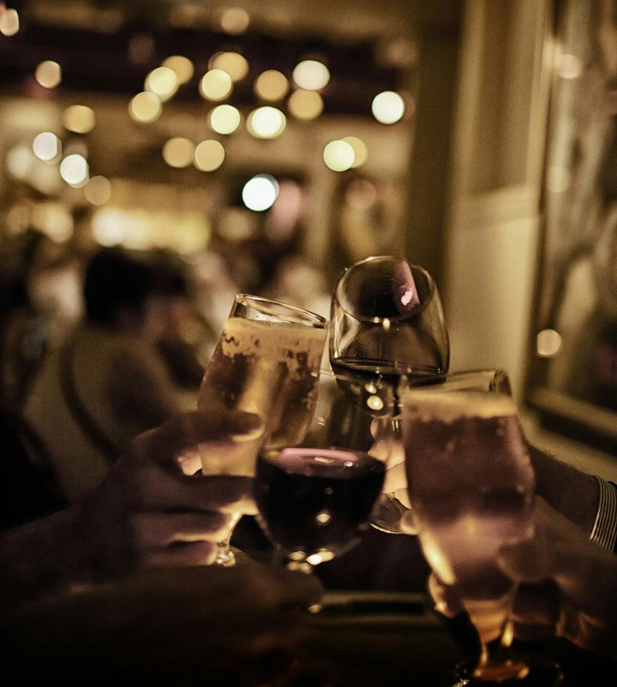 a close up of a person holding a wine glass